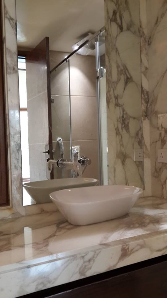 Square vessel sink with beige stone counter and frameless glass shower — Bathroom 2, GK I Residence