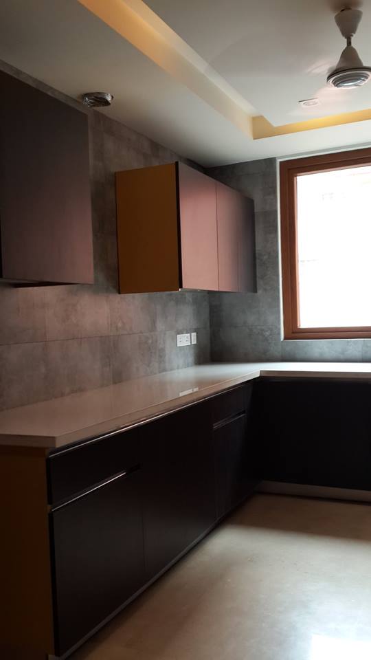 Full galley kitchen view with white gloss cabinets and integrated appliances — GK I Residence