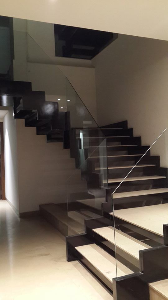 Custom staircase with feature detailing and wood accents — GK I Residence