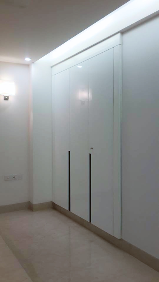 Second wardrobe with full-height fitted joinery and loft storage — Green Park Residence