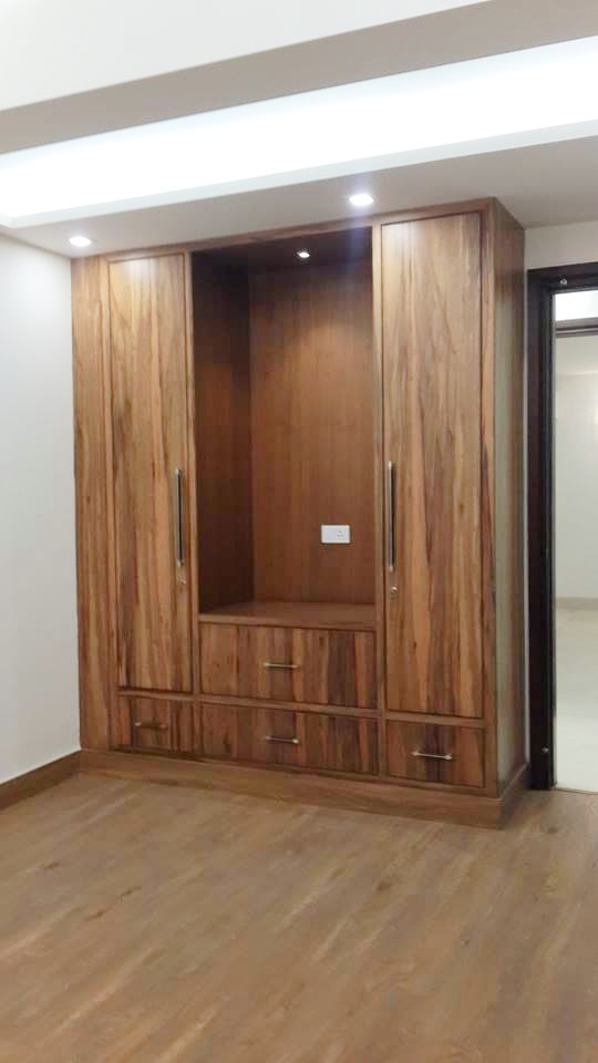 Integrated TV unit incorporated into the wardrobe joinery run for a seamless fitted wall — Green Park Residence