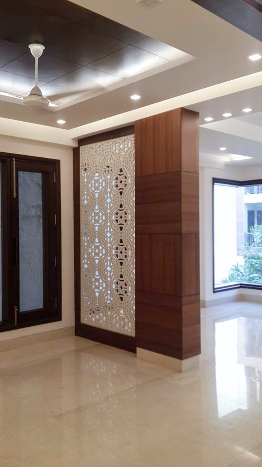 Decorative wall partition with open shelving and backlit niches as living room focal point — Green Park Residence