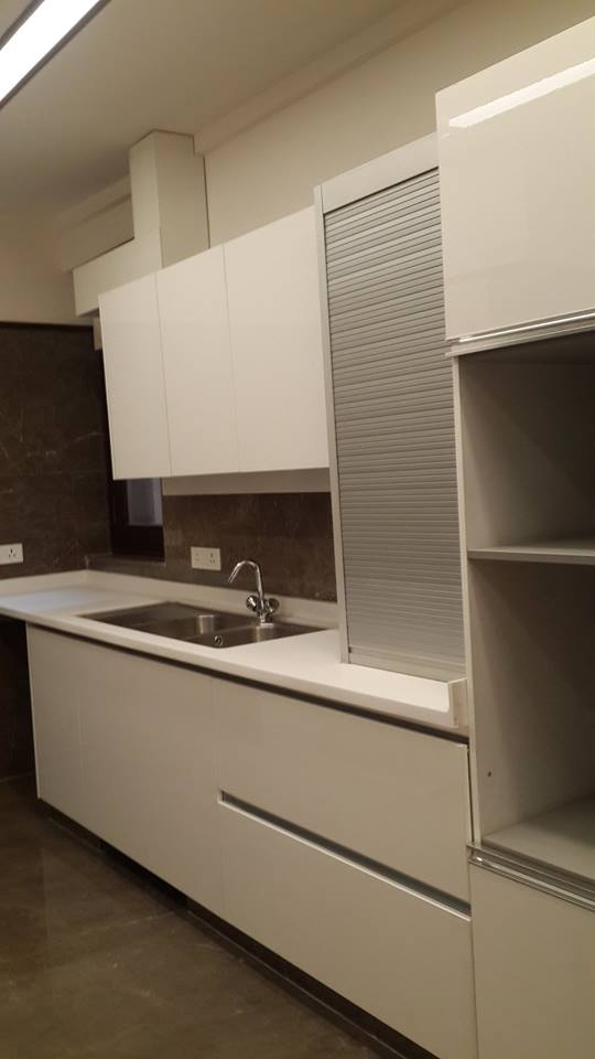 Second kitchen run with integrated hob and overhead cabinets — Green Park Residence
