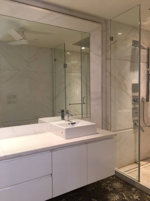Bathroom 1 — Statuario white marble with floor-to-ceiling cladding and oval vessel sink — Maharani Bagh Residence