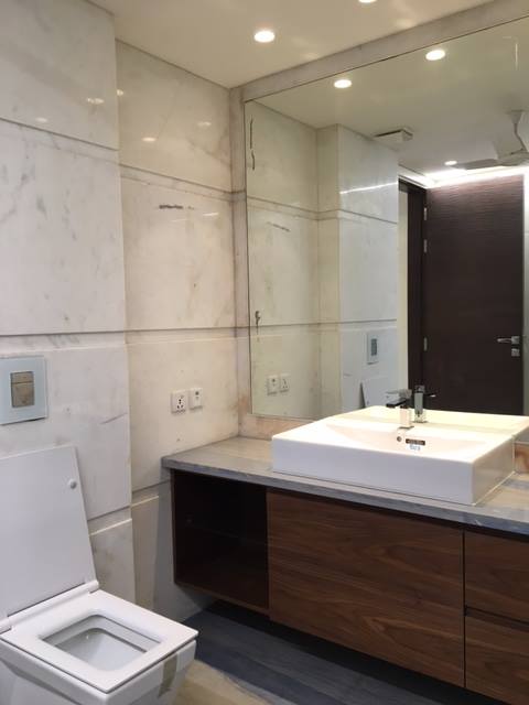 Bathroom 2 — Nero Marquina black marble with gold-tone fixtures and frameless shower — Maharani Bagh Residence