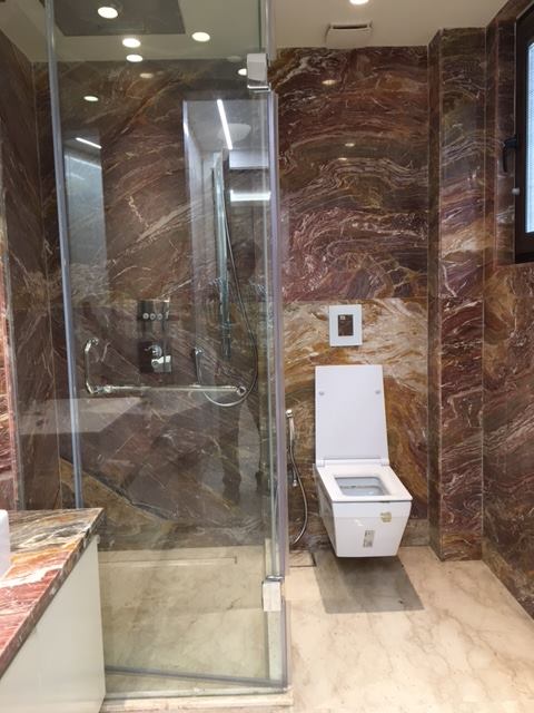 Bathroom 5 — Indian green marble with chrome wall-mount faucet and glass shower enclosure — Maharani Bagh Residence