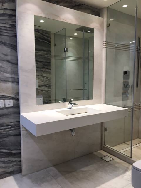 Bathroom 7 — Rose marble with freestanding bath, designer fixtures and full-height stone feature wall — Maharani Bagh Residence